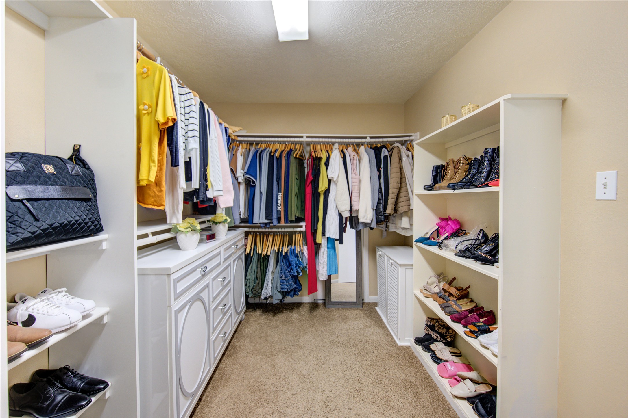 14902 Englebrook Drive Houston, TX 77095 - Photo 43 of 50 a view of walk in closet with clothes and shoes