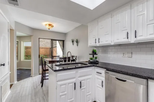 a kitchen with stainless steel appliances granite countertop a sink stove and cabinets