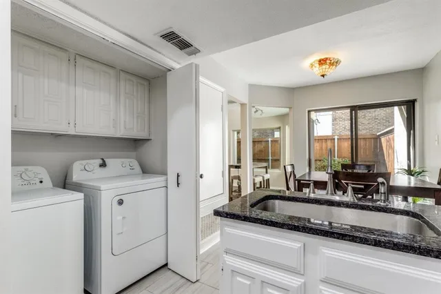 a kitchen with stove cabinets and a sink