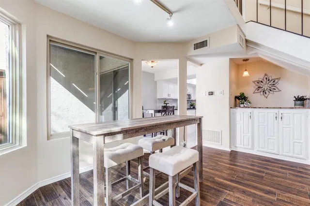 a view of a dining room with furniture and a window