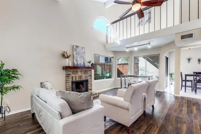 a living room with furniture a fireplace and a potted plant