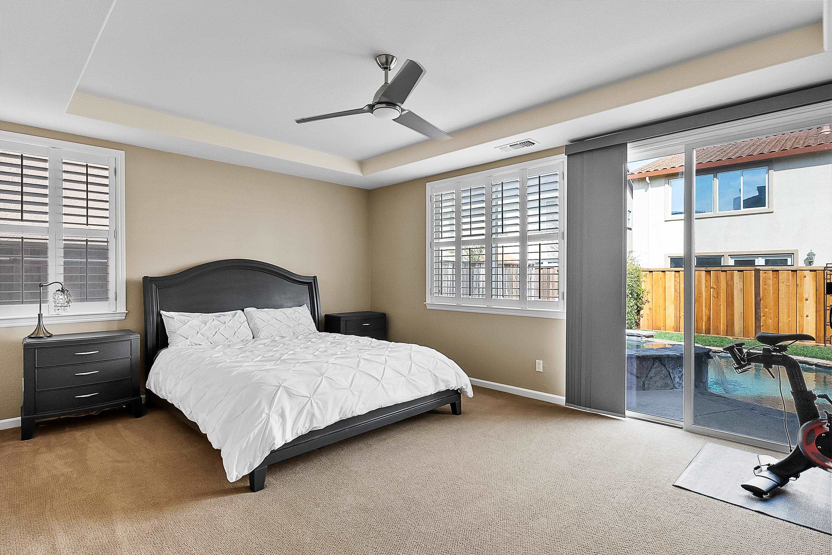 5282 Fern Ridge Circle Discovery Bay, CA 94505 - Photo 17 of 41 a bedroom with a bed a table and painting on the wall