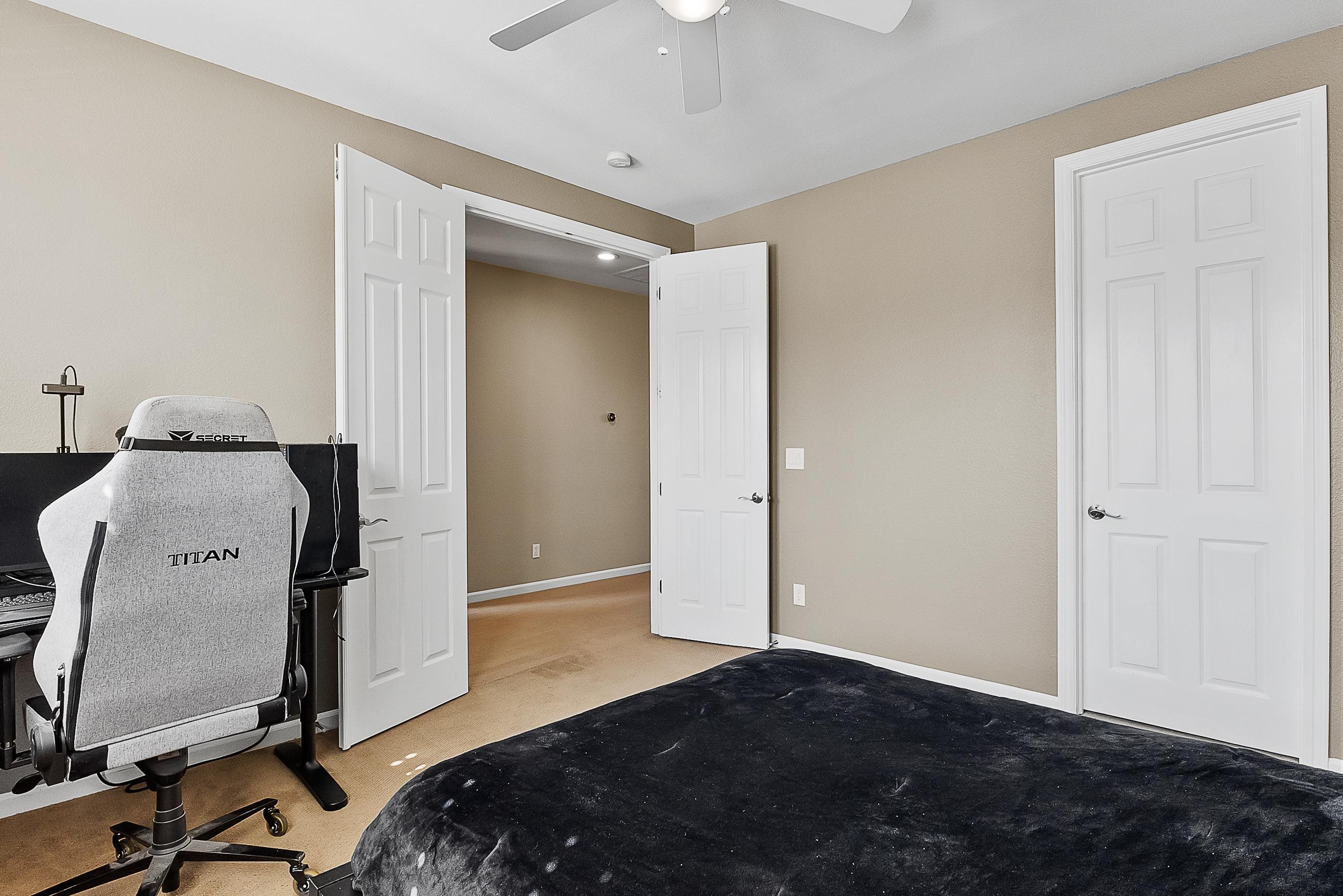 5282 Fern Ridge Circle Discovery Bay, CA 94505 - Photo 28 of 41 a bedroom with a bed and a chandelier