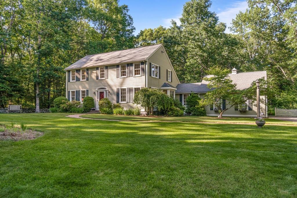 9 Deepwoods Drive Natick, MA 01760 - Photo 1 of 31 a front view of a house with a yard table and chairs