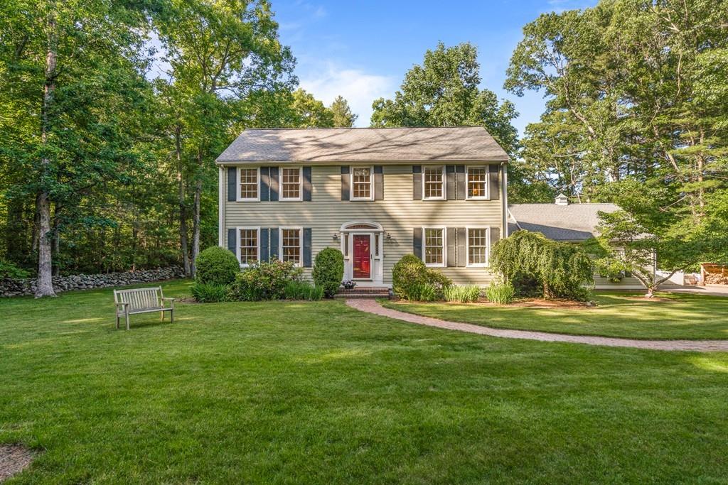 9 Deepwoods Drive Natick, MA 01760 - Photo 2 of 31 a front view of a house with a yard table and chairs