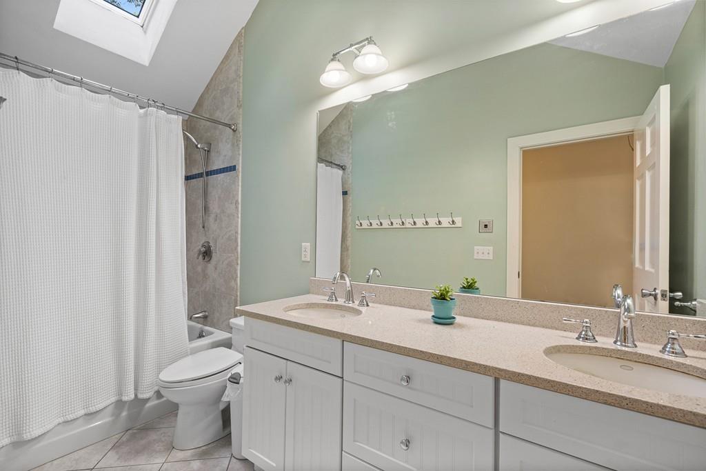 9 Deepwoods Drive Natick, MA 01760 - Photo 21 of 31 a bathroom with a double vanity sink mirror and toilet