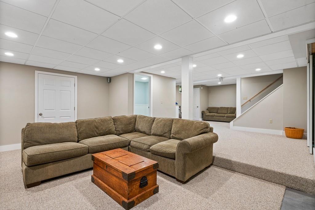 9 Deepwoods Drive Natick, MA 01760 - Photo 24 of 31 a living room with furniture and a couch