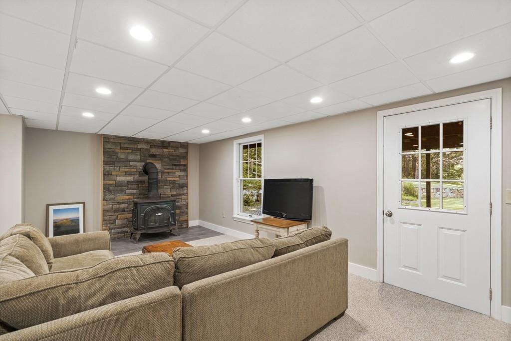 9 Deepwoods Drive Natick, MA 01760 - Photo 27 of 31 a living room with furniture and a flat screen tv