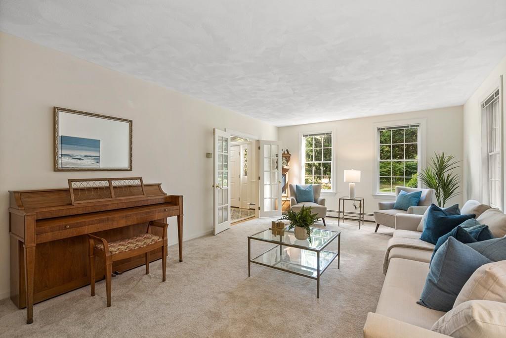 9 Deepwoods Drive Natick, MA 01760 - Photo 4 of 31 a living room with furniture and a piano