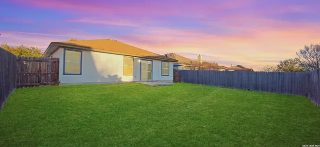 a house view with a backyard space