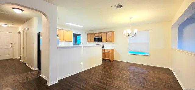 a view of a kitchen with wooden floor and a sink