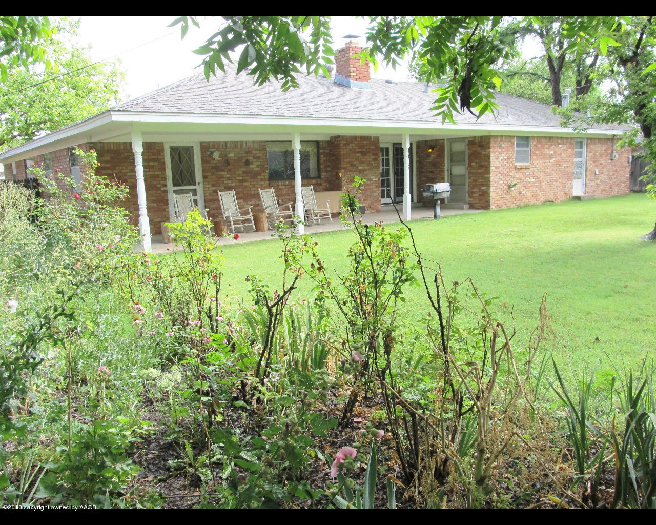 6707 Elmhurst Road Amarillo, TX 79106 - Photo 20 of 21 a view of a house with pool and garden