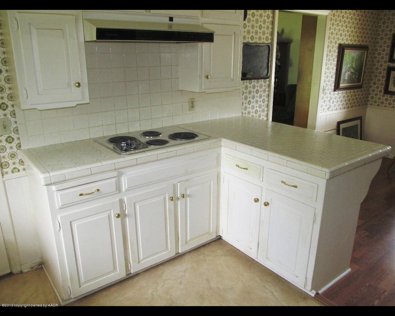 6707 Elmhurst Road Amarillo, TX 79106 - Photo 7 of 21 a kitchen with white cabinets