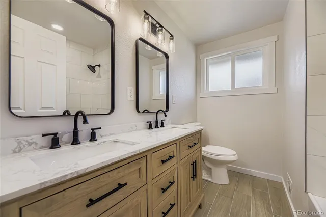 a bathroom with 2 sink and a mirror