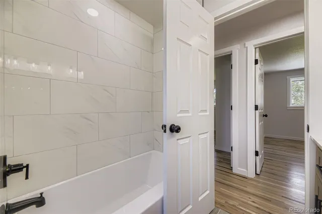 a bathroom with a bathtub and a shower