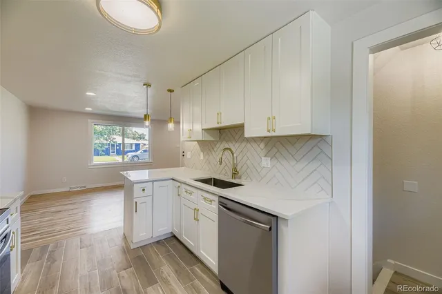 a kitchen with stainless steel appliances granite countertop a sink stove and cabinets