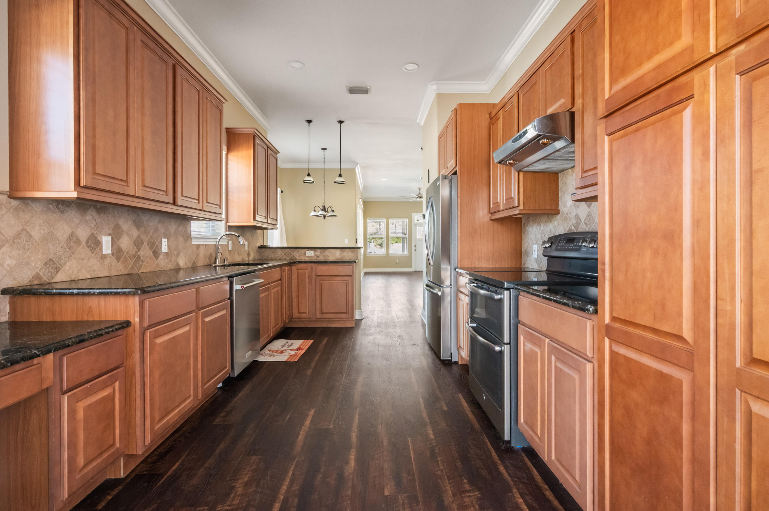 722 Kelly Street Destin, FL 32541 - Photo 12 of 54 a kitchen with stainless steel appliances granite countertop a stove a sink and a refrigerator