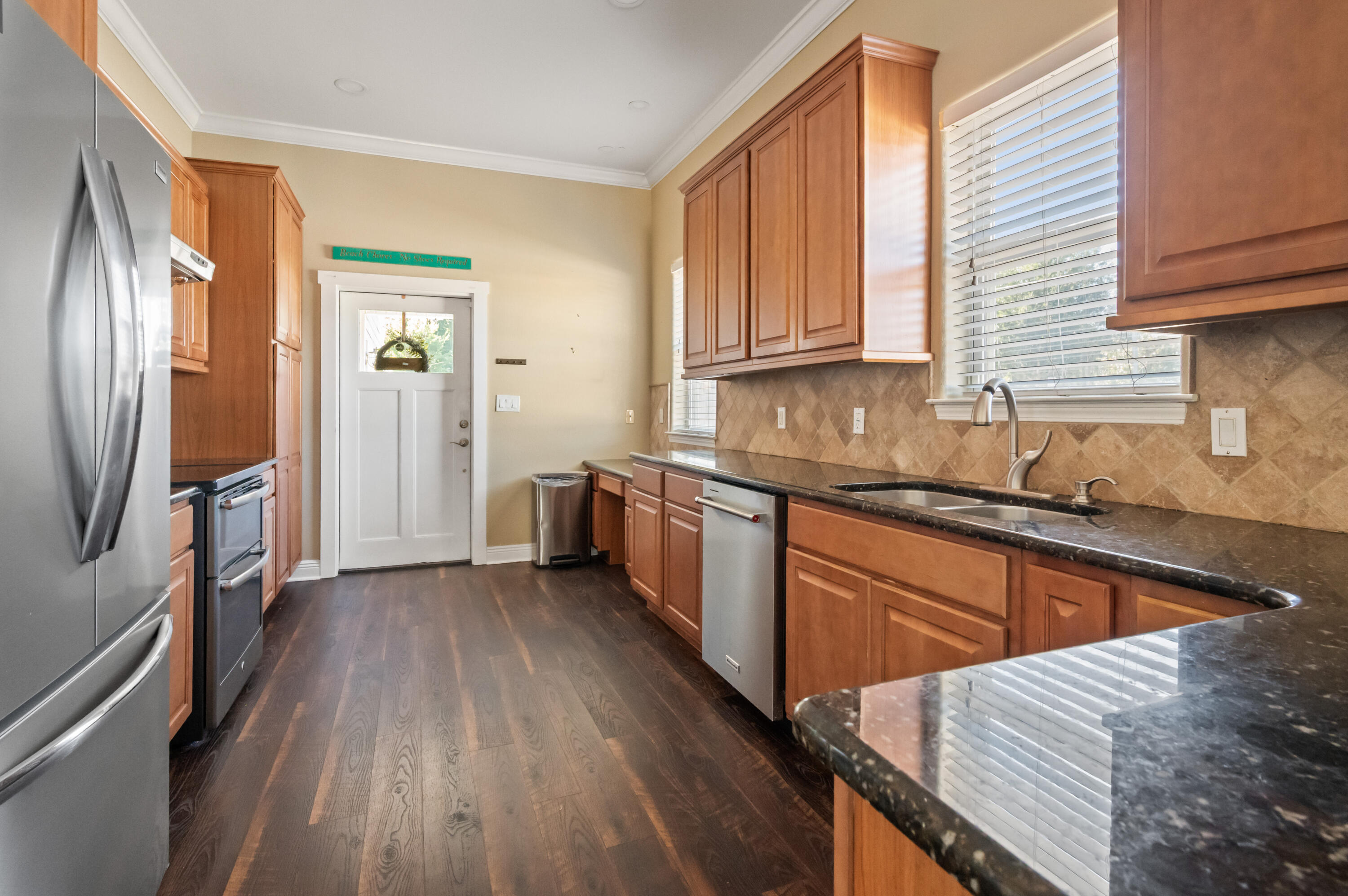 722 Kelly Street Destin, FL 32541 - Photo 14 of 54 a kitchen with stainless steel appliances granite countertop a refrigerator a sink dishwasher a stove and white countertops with wooden floor