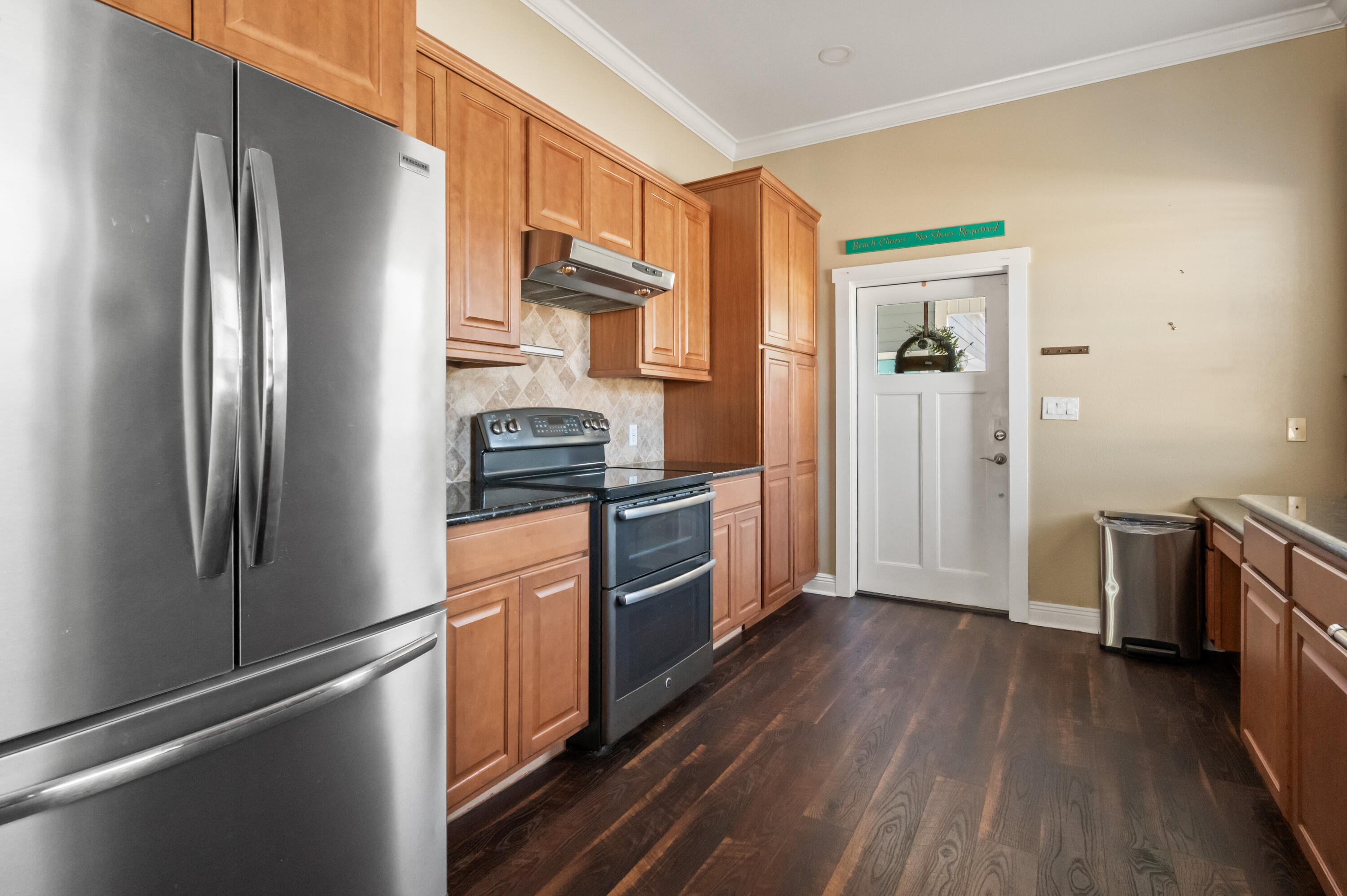 722 Kelly Street Destin, FL 32541 - Photo 15 of 54 a kitchen with stainless steel appliances a refrigerator stove and wooden floor