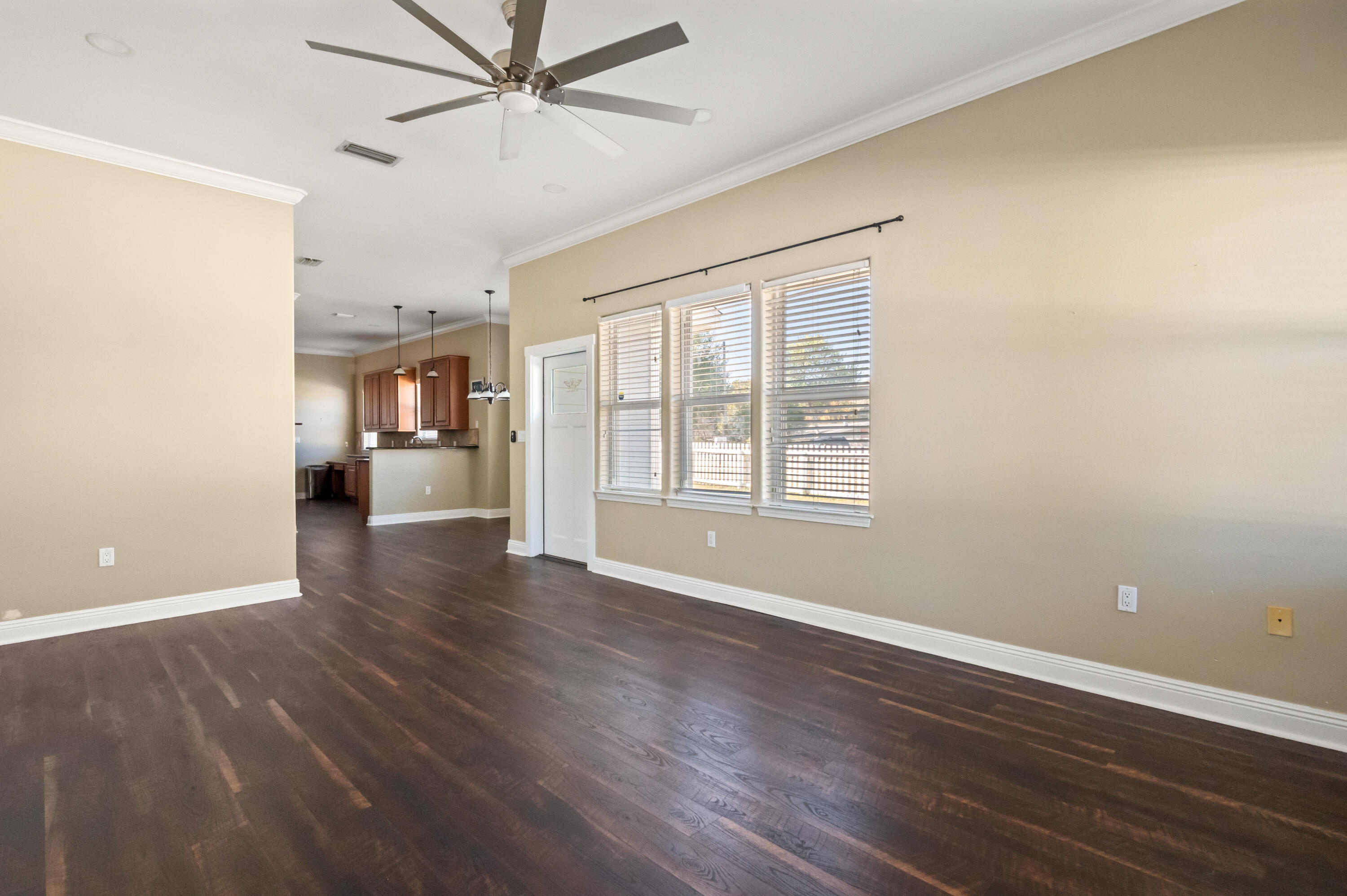 722 Kelly Street Destin, FL 32541 - Photo 20 of 54 an empty room with wooden floor fan and windows