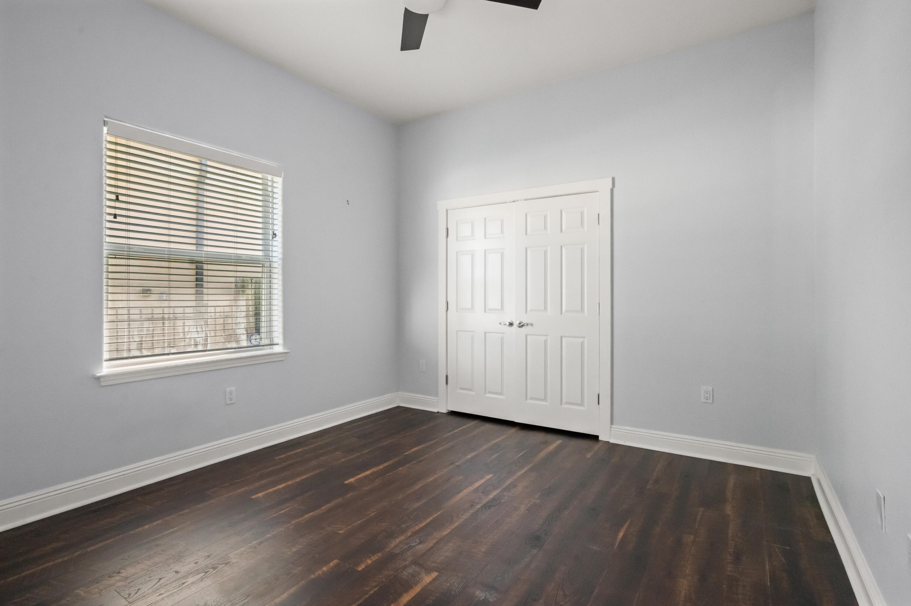 722 Kelly Street Destin, FL 32541 - Photo 29 of 54 an empty room with wooden floor and windows