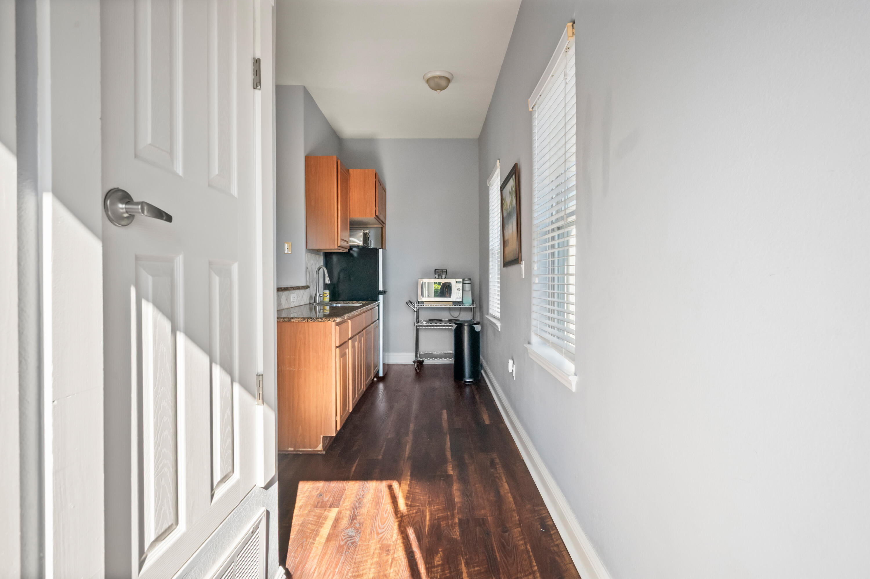 722 Kelly Street Destin, FL 32541 - Photo 31 of 54 a view of a hallway with wooden floor and staircase