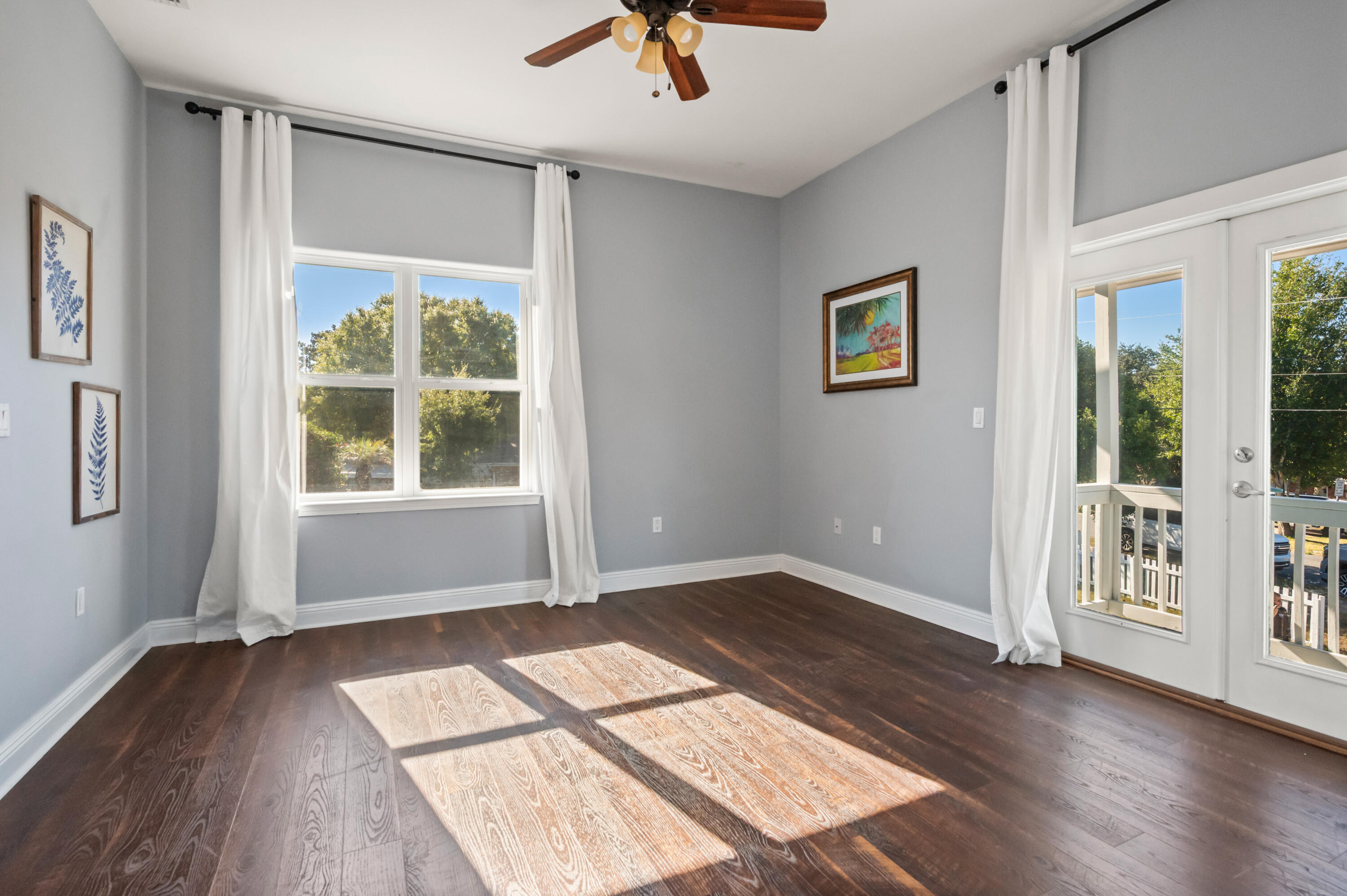 722 Kelly Street Destin, FL 32541 - Photo 34 of 54 an empty room with wooden floor and windows