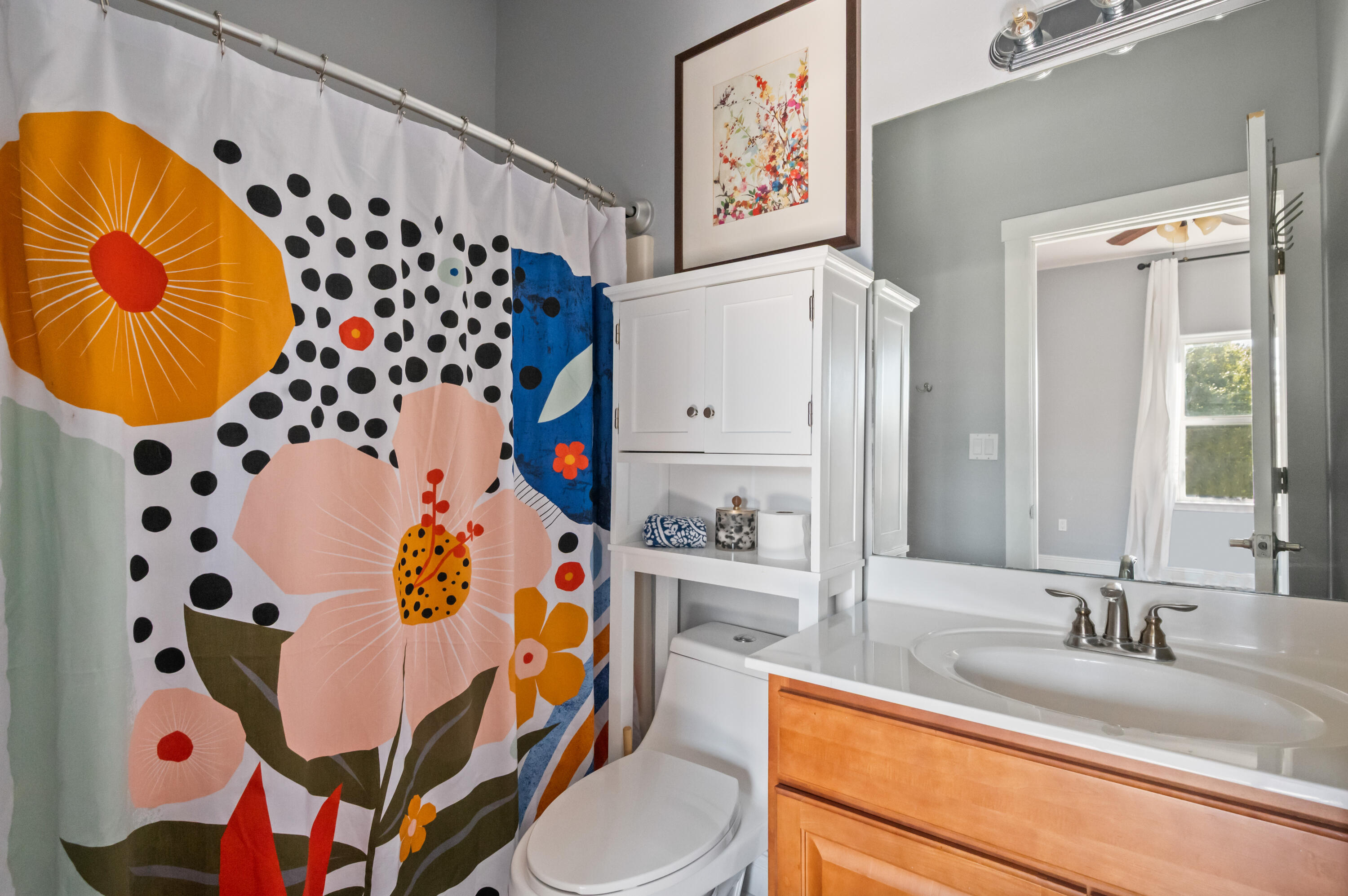 722 Kelly Street Destin, FL 32541 - Photo 37 of 54 a bathroom with a sink and mirror with toilet