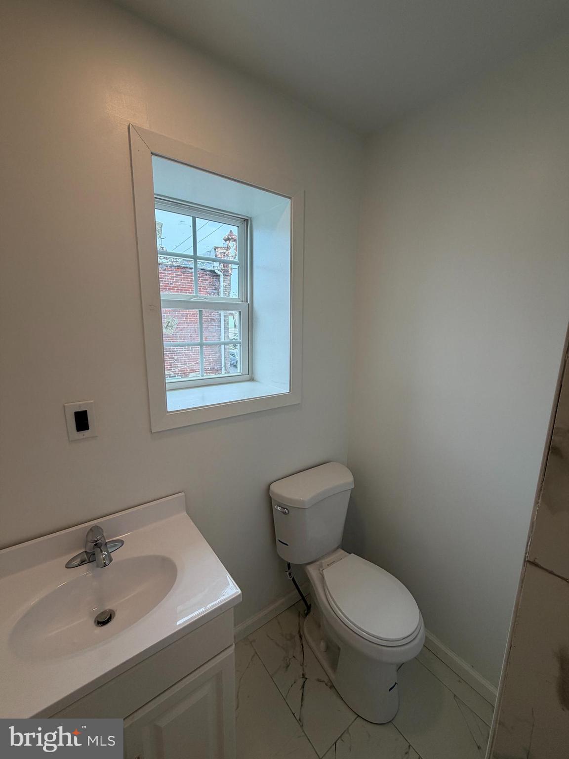3760 North 9th Street Philadelphia, PA 19140 - Photo 4 of 17 a bathroom with a toilet sink vanity and mirror