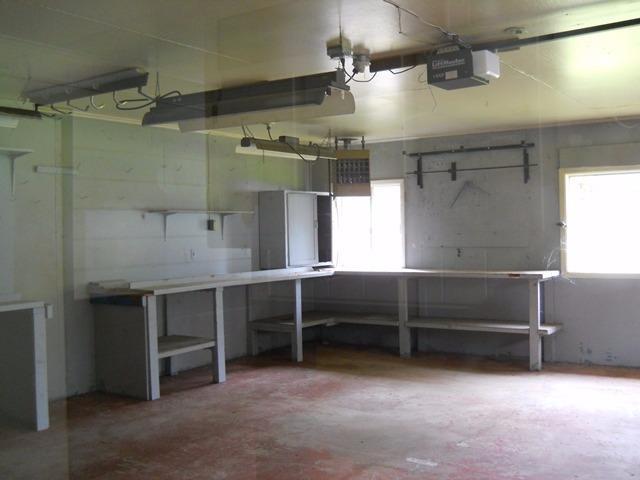 9610 Old Stage Road Central Point, OR 97502 - Photo 15 of 15 Large garage with benches and shelving.