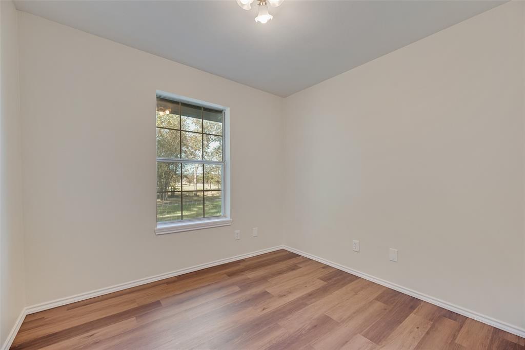 751 County Road 1240 Mount Pleasant, TX 75455 - Photo 26 of 35 an empty room with wooden floor and windows