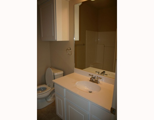 14521 East Cabana Street, Unit 503 Corpus Christi, TX 78418 - Photo 6 of 10 a bathroom with a sink toilet and mirror