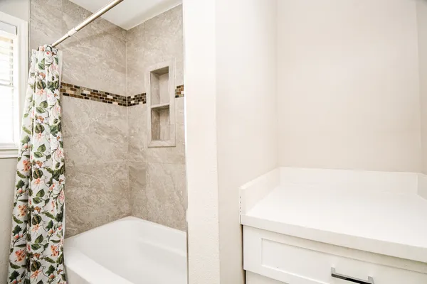 a bathroom with a bathtub and shower