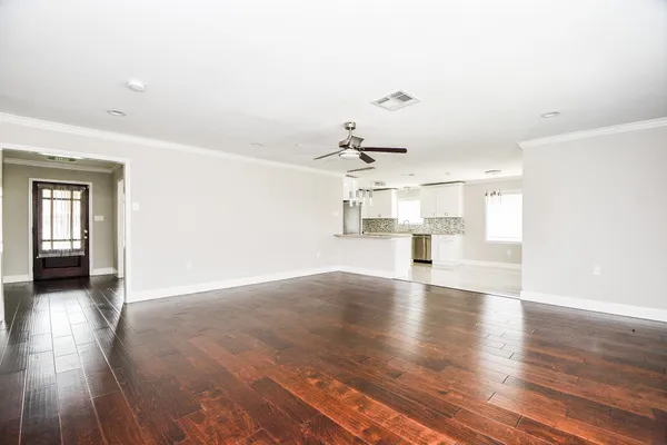 wooden floor in an empty room with a window
