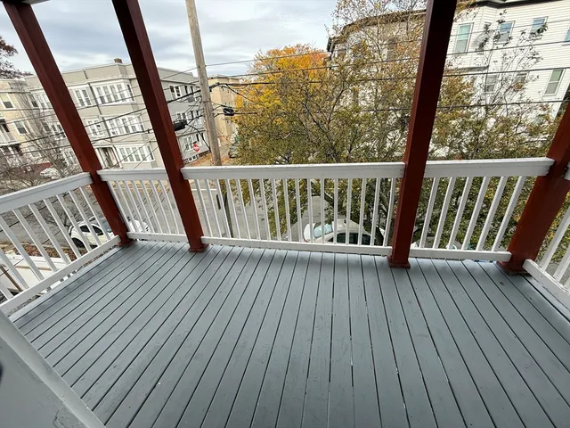 a view of balcony with wooden floor