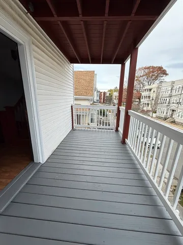 a view of a balcony with wooden floor