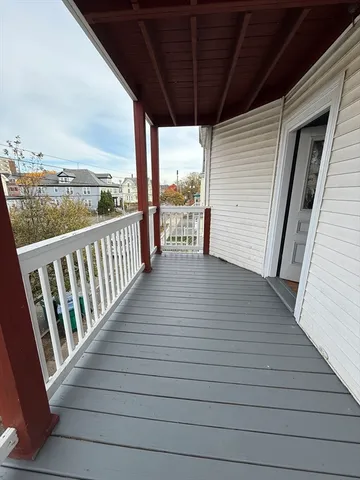 a view of a balcony with wooden floor