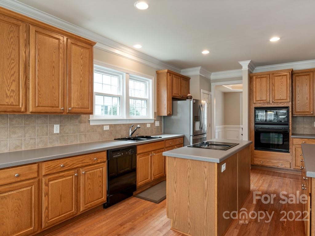 8603 Dansington Court Waxhaw, NC 28173 - Photo 11 of 45 a kitchen with stainless steel appliances granite countertop a stove a sink and a microwave