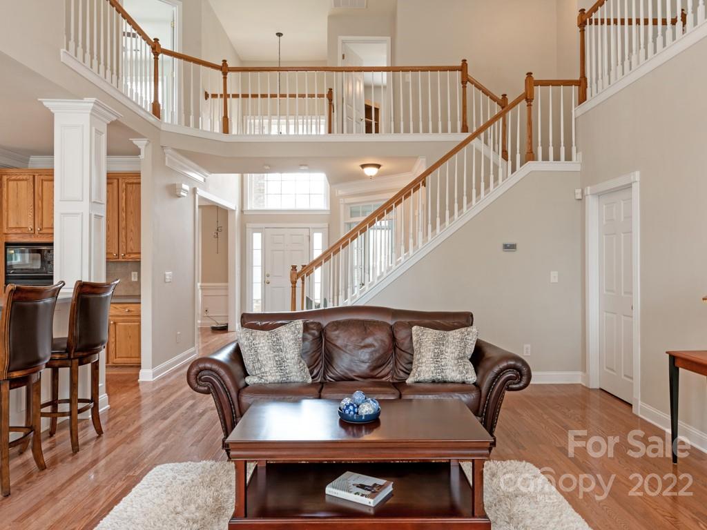 8603 Dansington Court Waxhaw, NC 28173 - Photo 16 of 45 a living room with furniture a rug and a chandelier