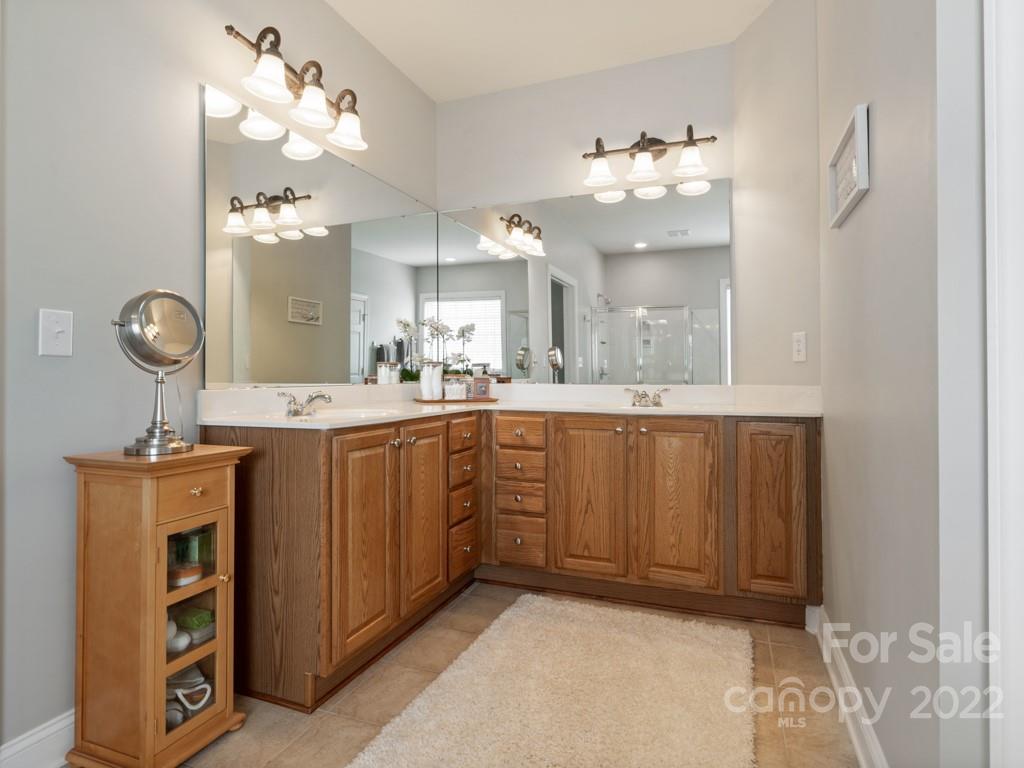 8603 Dansington Court Waxhaw, NC 28173 - Photo 24 of 45 a bathroom with a sink vanity and mirror