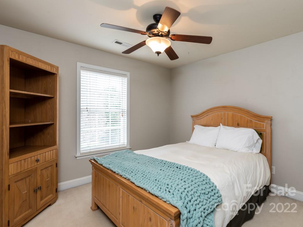 8603 Dansington Court Waxhaw, NC 28173 - Photo 32 of 45 a bedroom with a large bed and a window