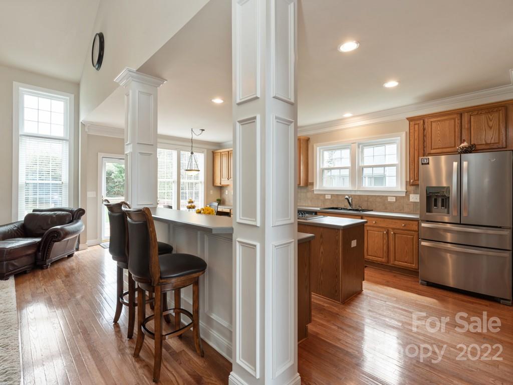 8603 Dansington Court Waxhaw, NC 28173 - Photo 8 of 45 a kitchen with refrigerator cabinets dining table and chairs