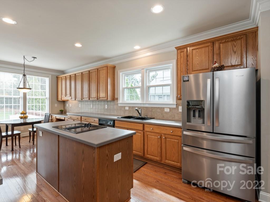 8603 Dansington Court Waxhaw, NC 28173 - Photo 9 of 45 a kitchen with stainless steel appliances granite countertop a stove a sink dishwasher a refrigerator and wooden cabinets