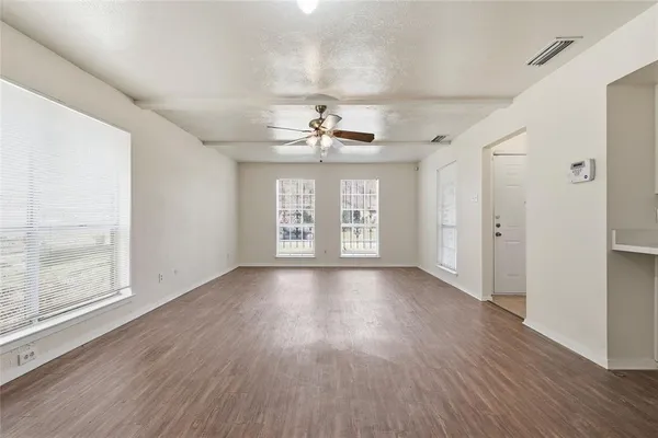 wooden floor in an empty room with a window