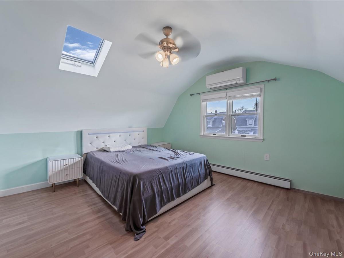 217-32 Corbett Road Queens, NY 11361 - Photo 18 of 25 a bedroom with a bed and a chandelier
