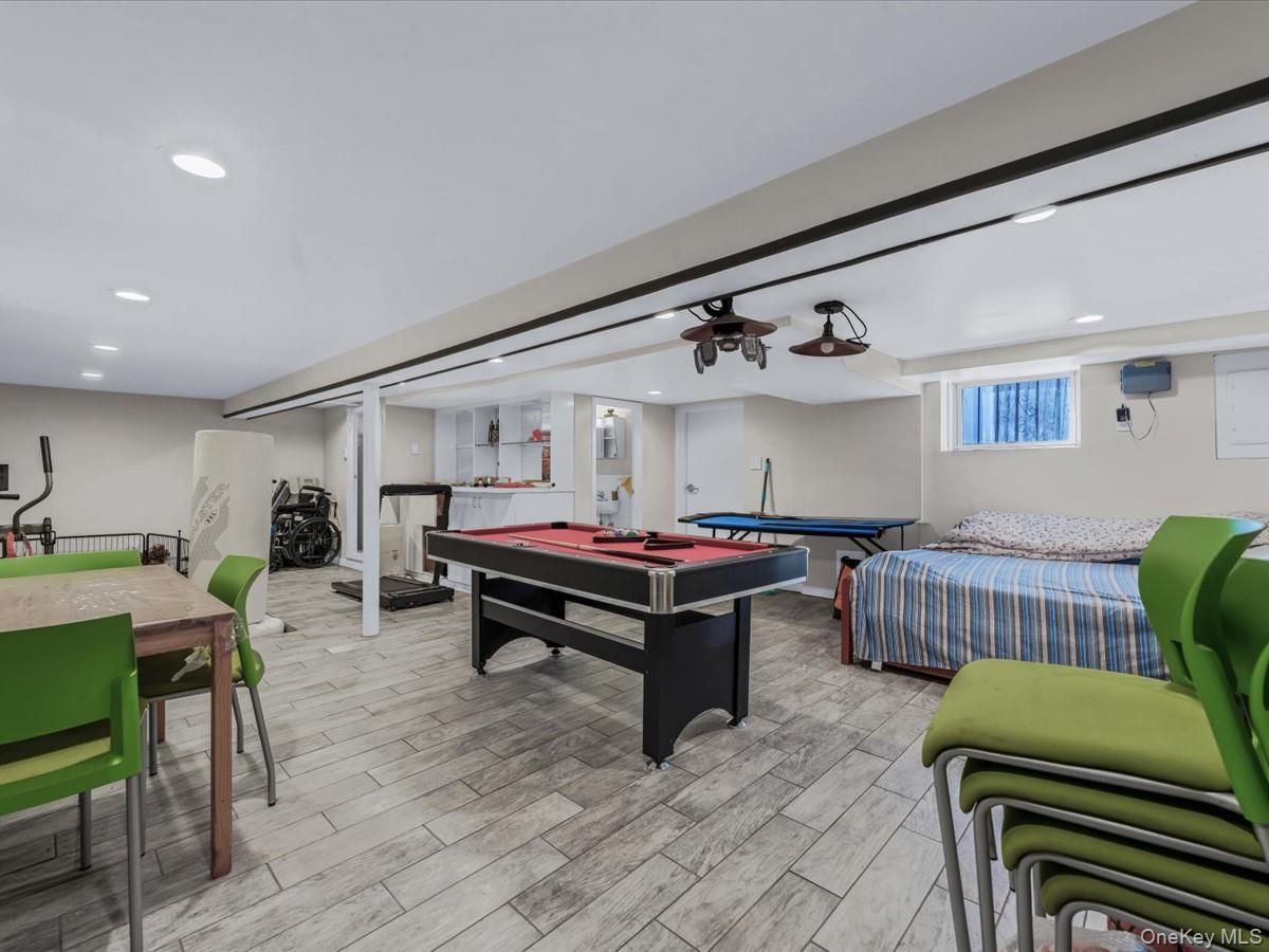 217-32 Corbett Road Queens, NY 11361 - Photo 21 of 25 a living room with furniture and a wooden floor