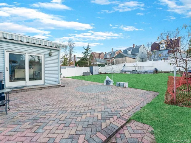 a view of a backyard with plants and a patio