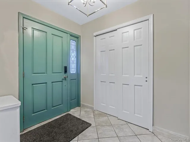 a view of an empty room with closet and wooden floor