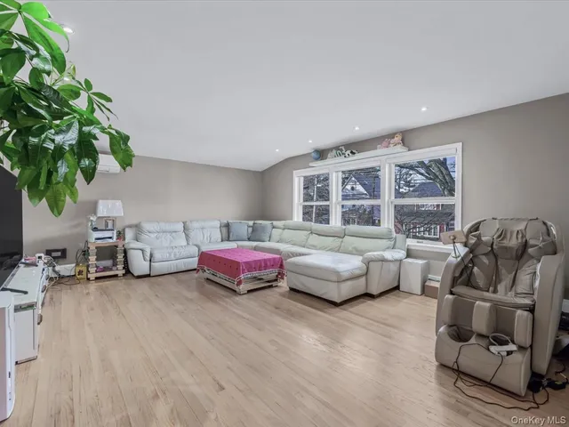 a bedroom with furniture and a large window