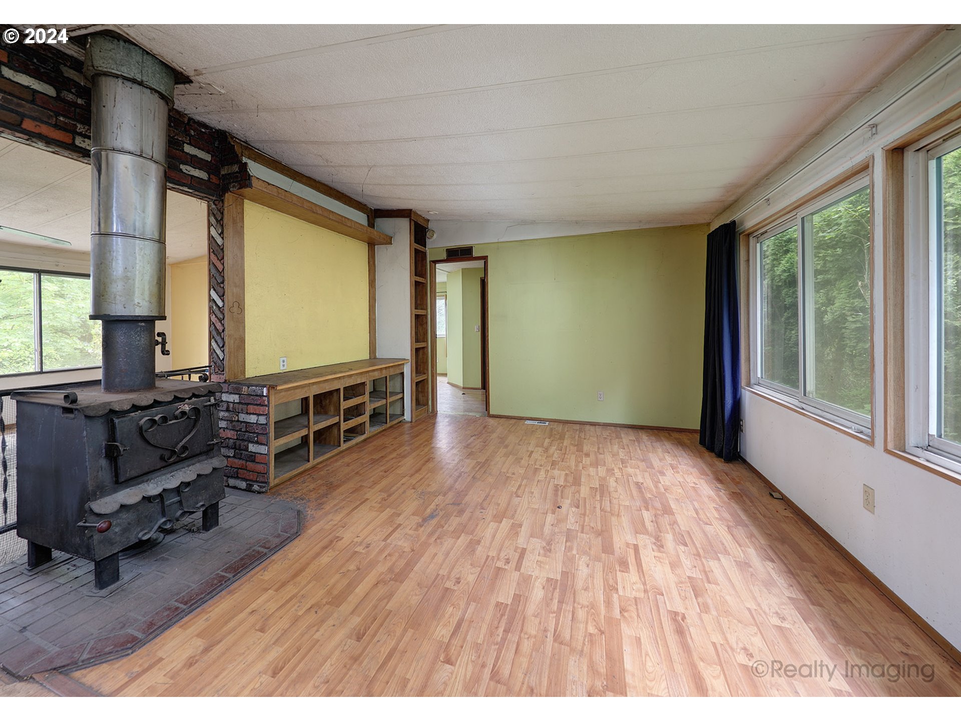 48886 Southeast Coalman Road Sandy, OR 97055 - Photo 4 of 16 a living room with furniture flat screen tv and wooden floor